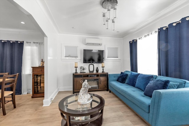 living room with crown molding, light wood-type flooring, and a wall unit AC