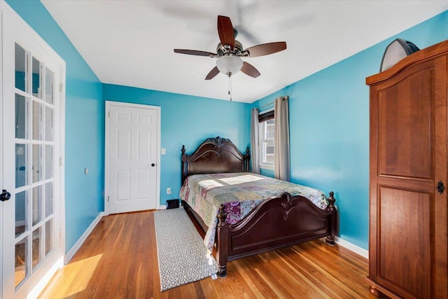 bedroom featuring ceiling fan, baseboards, and wood finished floors