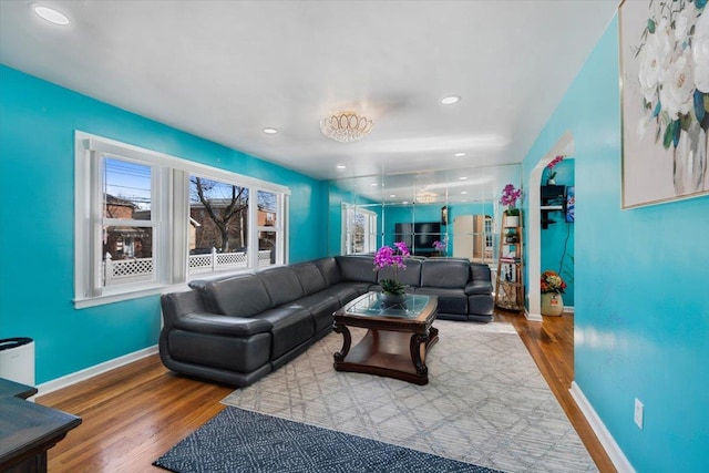 living area featuring recessed lighting, baseboards, and wood finished floors