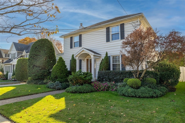 colonial inspired home with a front yard