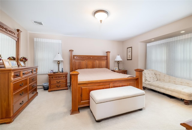 carpeted bedroom featuring a baseboard heating unit