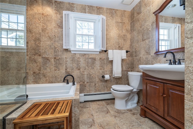 bathroom featuring vanity, tile walls, a bath, and a baseboard radiator