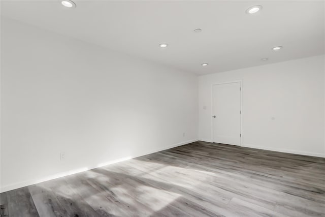 spare room with wood-type flooring