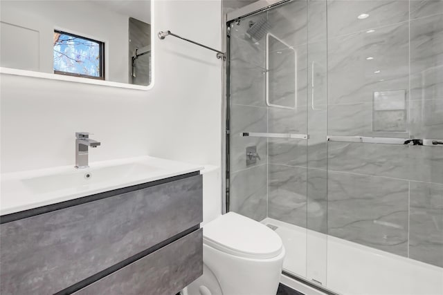 bathroom with vanity, toilet, and walk in shower