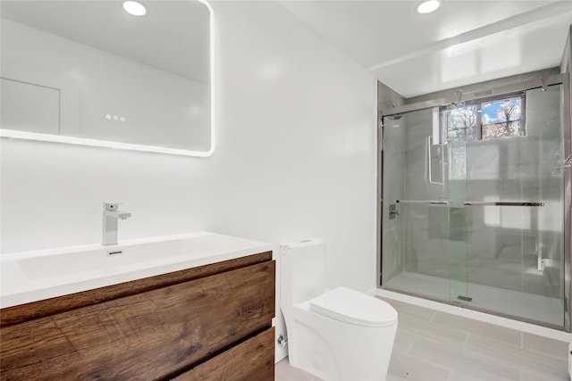 bathroom with vanity, toilet, walk in shower, and tile patterned floors