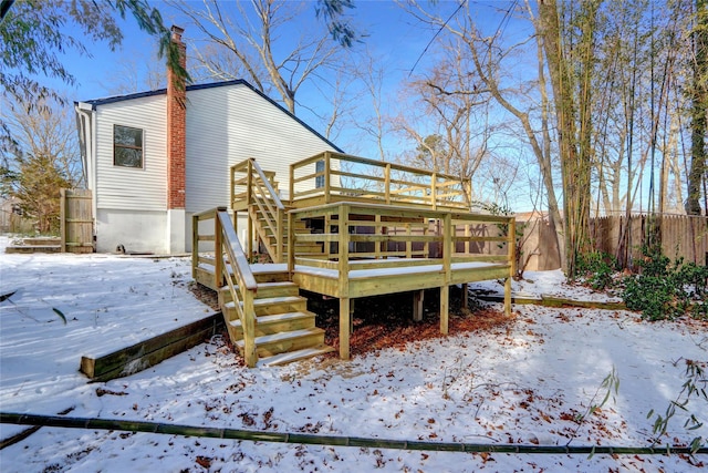 snow covered property featuring a deck