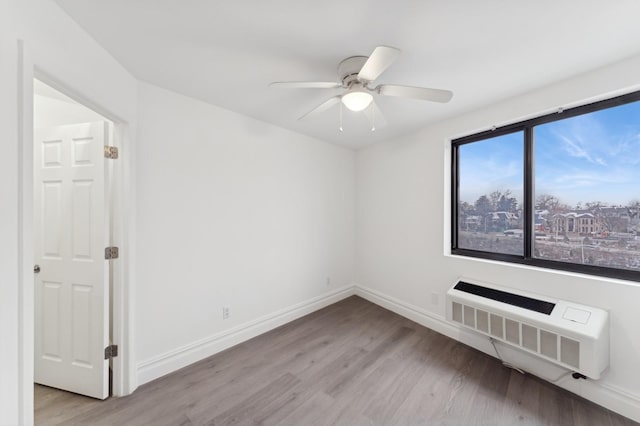 unfurnished room with ceiling fan, radiator, and light wood-type flooring