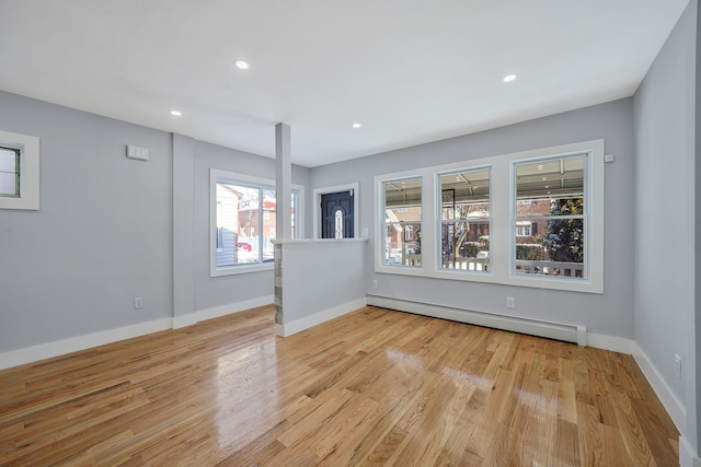 spare room featuring light hardwood / wood-style floors and a baseboard radiator