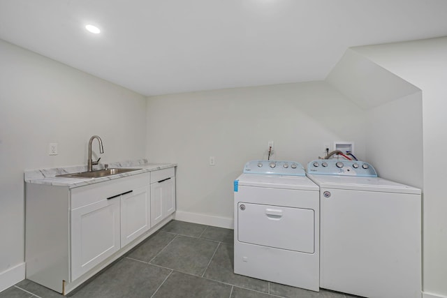 washroom with cabinets, sink, dark tile patterned flooring, and washing machine and clothes dryer