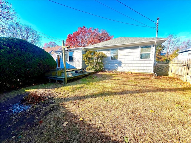 rear view of house featuring a lawn