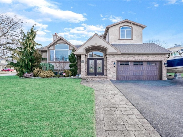 view of front of property with french doors, a garage, and a front yard