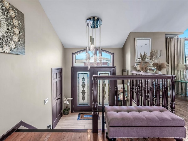 foyer entrance featuring lofted ceiling and light hardwood / wood-style floors