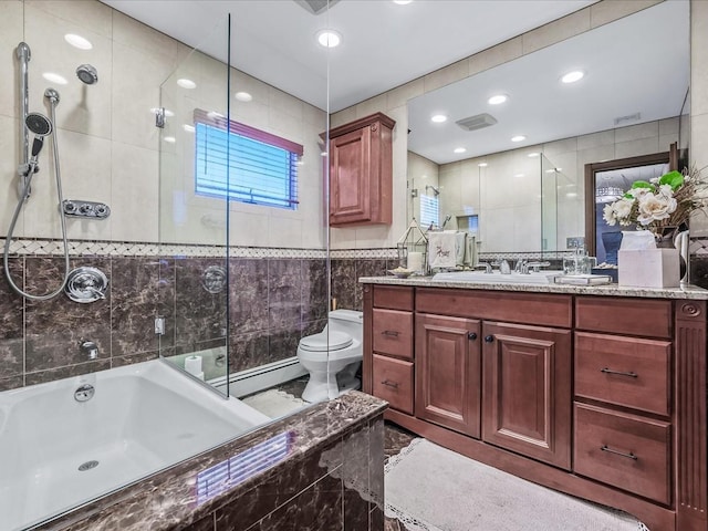 full bathroom featuring a baseboard radiator, tiled shower / bath combo, vanity, tile walls, and toilet