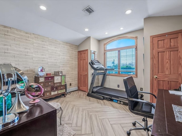 workout room featuring wood walls, light parquet floors, and lofted ceiling