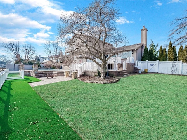 view of yard with a deck and a patio