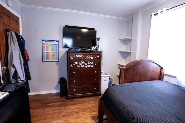 bedroom featuring hardwood / wood-style floors and ornamental molding