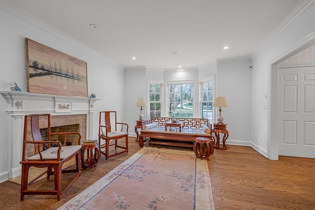 sitting room featuring crown molding and hardwood / wood-style flooring