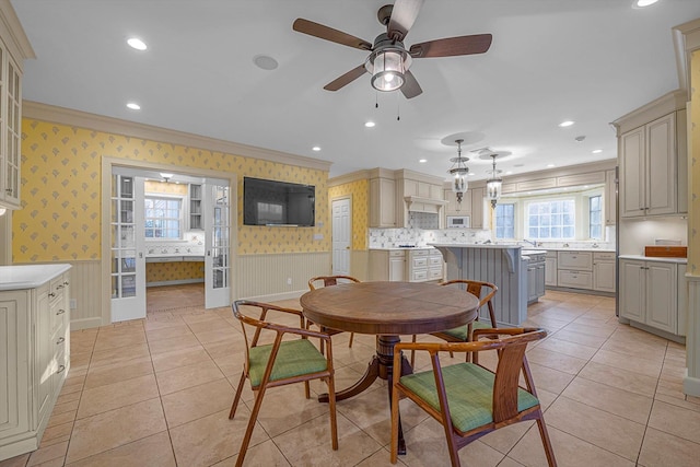 dining room featuring light tile patterned floors, ceiling fan, ornamental molding, and french doors