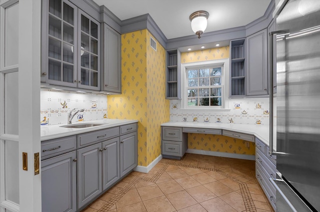 kitchen with light tile patterned floors, stainless steel built in fridge, sink, and gray cabinets