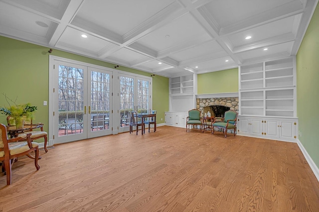 sitting room with built in shelves, beamed ceiling, french doors, light hardwood / wood-style flooring, and coffered ceiling