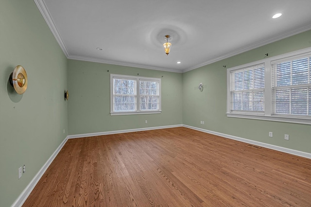 unfurnished room with hardwood / wood-style flooring and ornamental molding