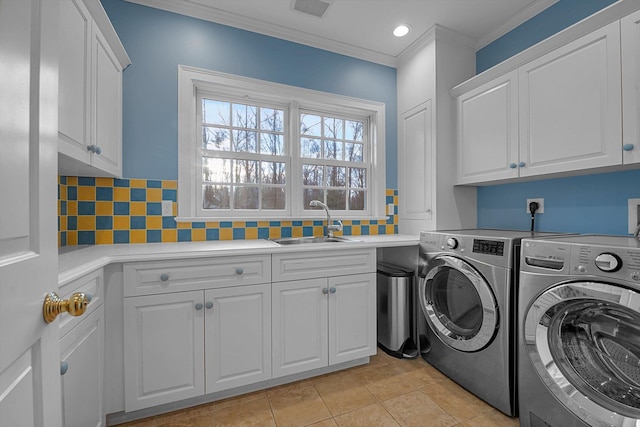 washroom with washer and dryer, cabinets, sink, ornamental molding, and light tile patterned floors