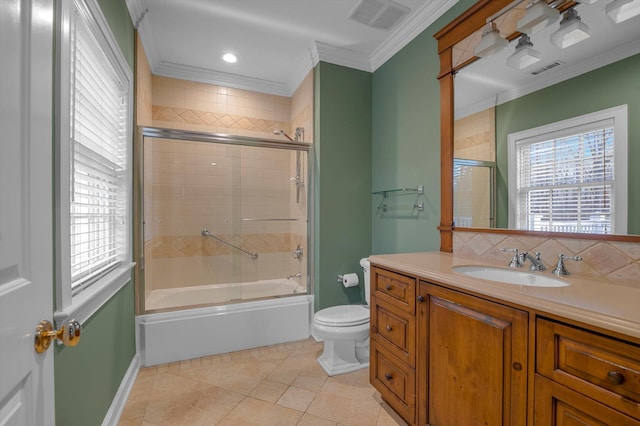 full bathroom with tile patterned flooring, vanity, bath / shower combo with glass door, toilet, and crown molding