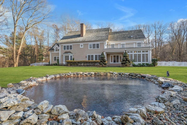 rear view of property with a lawn