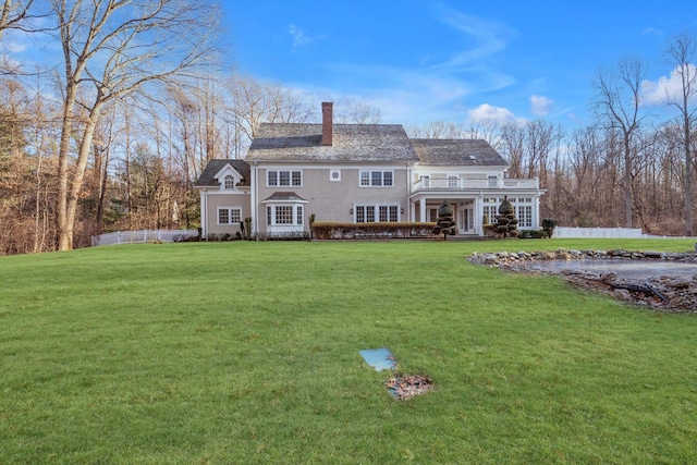 rear view of property featuring a yard