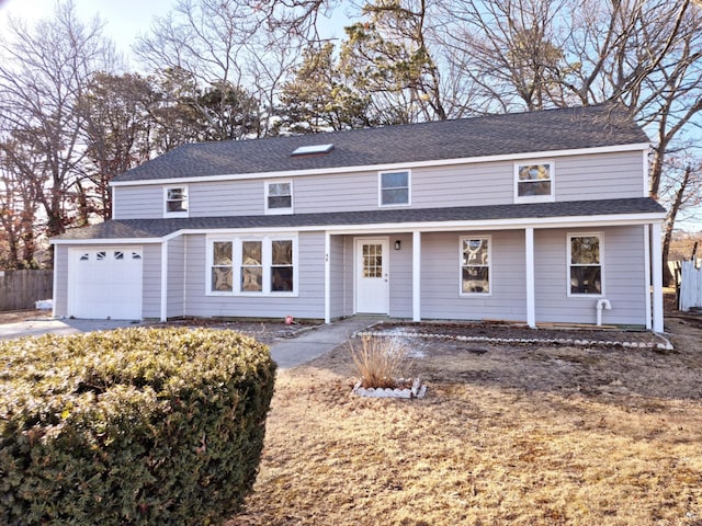 traditional-style home with roof with shingles and an attached garage