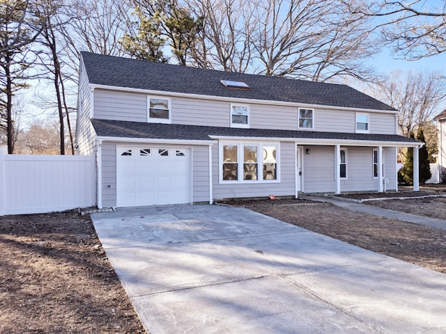 view of front of home featuring a garage, driveway, fence, and a shingled roof