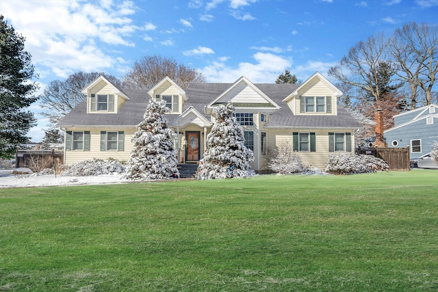 cape cod home with a front lawn