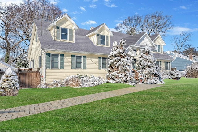 cape cod home with a front lawn