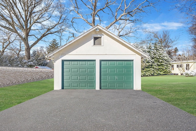 garage featuring a lawn