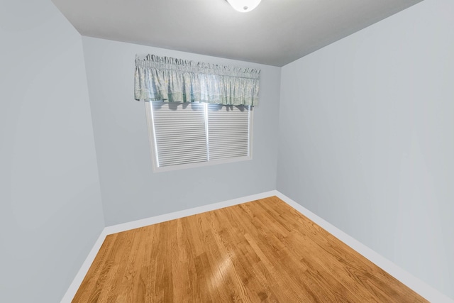 empty room with hardwood / wood-style flooring