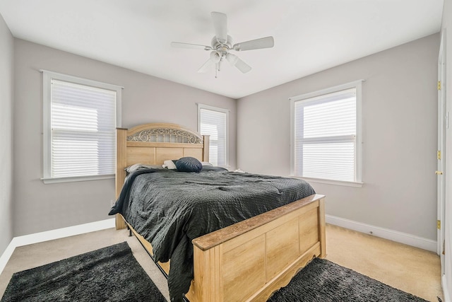 bedroom with ceiling fan and light colored carpet