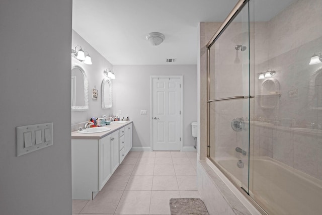 full bathroom featuring vanity, toilet, bath / shower combo with glass door, and tile patterned flooring