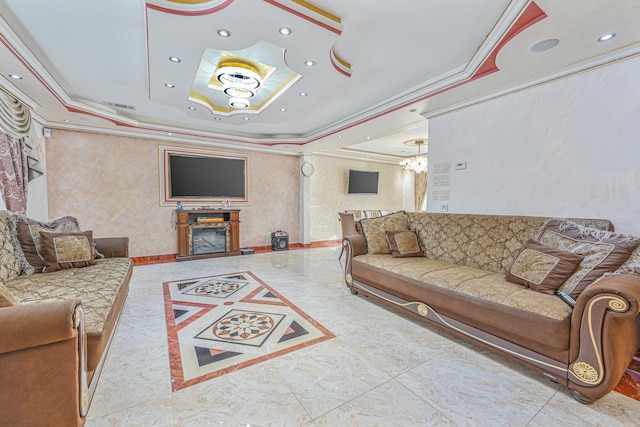 living room featuring ornamental molding, a chandelier, and a tray ceiling