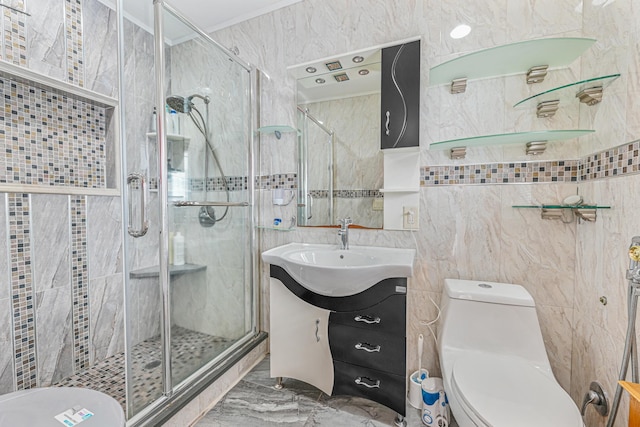 bathroom with crown molding, vanity, toilet, and a shower with door