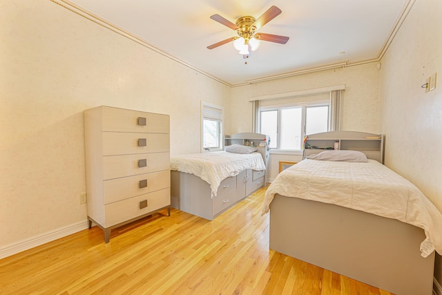 bedroom featuring crown molding, ceiling fan, and light wood-type flooring