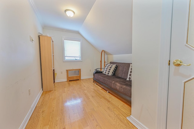 interior space with vaulted ceiling, crown molding, and light hardwood / wood-style floors