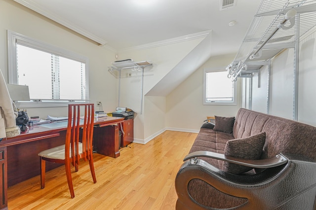 home office with crown molding, lofted ceiling, and light hardwood / wood-style floors