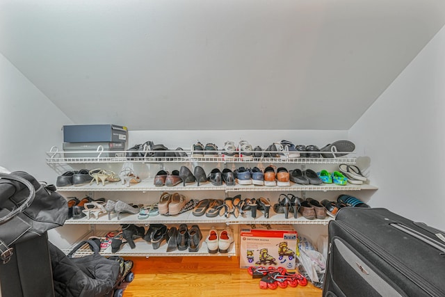 walk in closet featuring lofted ceiling and wood-type flooring