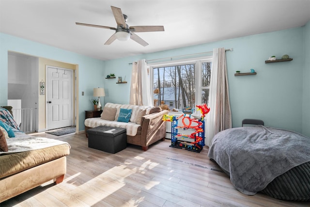 interior space with a baseboard heating unit, ceiling fan, and light hardwood / wood-style floors