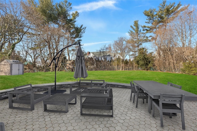 view of patio with a shed, an outdoor structure, and outdoor dining space