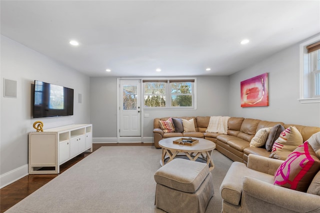 living room with dark wood-style floors, plenty of natural light, baseboards, and recessed lighting