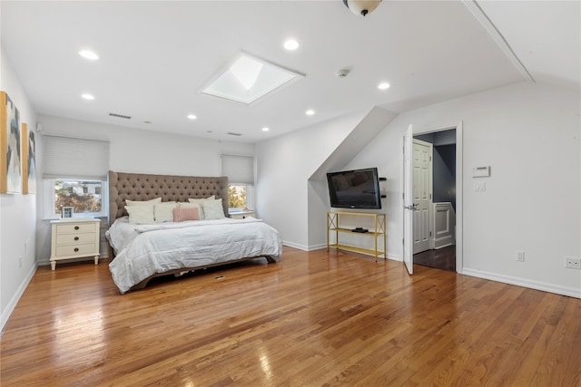 bedroom featuring a skylight, wood finished floors, and visible vents