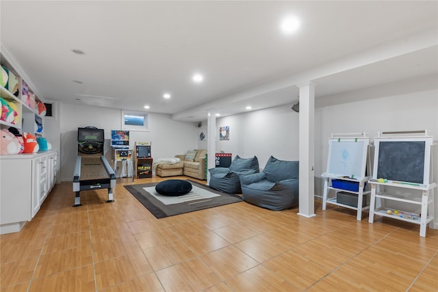 exercise area with light wood-style floors and recessed lighting