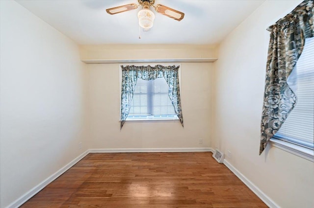 unfurnished room with hardwood / wood-style flooring and ceiling fan