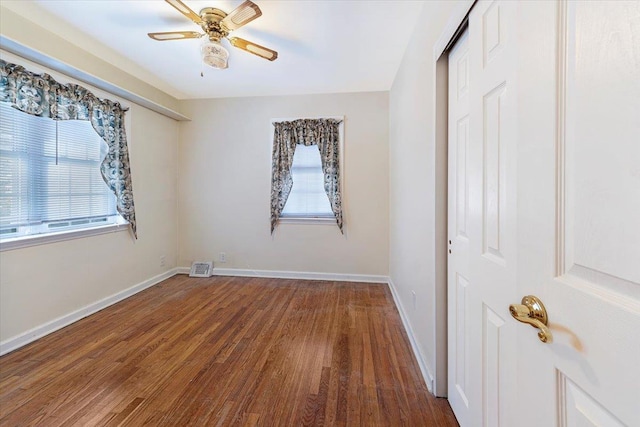 spare room featuring hardwood / wood-style flooring, plenty of natural light, and ceiling fan